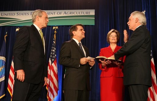 President George W. Bush listens as the Oath of Office is administered ceremoniously by Deputy Secretary Chuck Conner to U.S. Department of Agriculture Secretary Ed Schafer Wednesday, Feb. 6, 2008. Holding the Bible is Nancy Schafer, wife of the new secretary. White House photo by Chris Greenberg