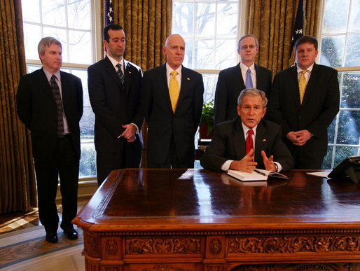 President George W. Bush speaks to the press after the signing of the 2008 Economic Report Monday Feb. 11, 2008, in the Oval Office. Joining President Bush are, from left, Chuck Blahous, Deputy Assistant to the President for Economic Policy; Pierce Scranton, Chief of Staff, Council of Economic Advisors; Eddie Lazear, Chairman, Council of Economic Advisors; Donald Marron, Senior Economic Advisor, Council of Economic Advisors; and Keith Hennessey, Assistant to the President for Economic Policy. White House photo by Joyce N. Boghosian