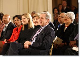 President George W. Bush, Mrs. Laura Bush, Jenna Bush and Secretary of State Condoleezza Rice join the East Room audience in listening to The Temptations Tuesday, Feb. 12, 2008, during a celebration of African American History Month. White House photo by Eric Draper