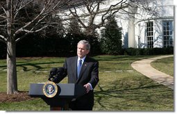 President George W. Bush talks with reporters Thursday, Feb. 14. 2008 on the South Lawn of the White House, urging members of Congress to pass the Protect America Act before legislation authorizing the monitoring of terrorist communications expires Saturday at midnight. White House photo by Chris Greenberg