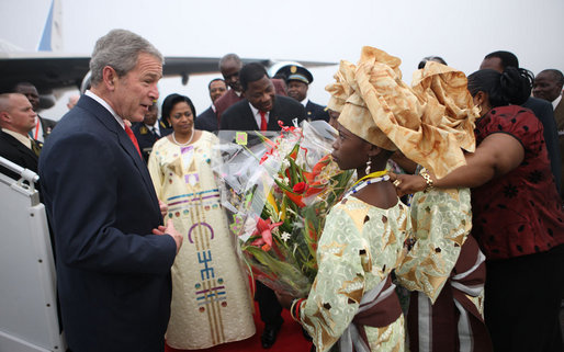 President George W. Bush is greeted by flower girls upon arrival Saturday, Feb. 6, 2008, at Cadjehoun International Airport in Cotonou, Benin, after he and Mrs. Laura Bush arrived at the first stop on their five-country, Africa visit. White House photo by Eric Draper