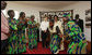 Mrs. Laura Bush and Madame Chantal de Souza Yayi, wife of President Boni Yayi of Benin, watch as representatives of the USAID-Supported Mothers' Association perform Saturday, Feb. 16, 2008, during their visit in Cotonou, Benin. White House photo by Shealah Craighead