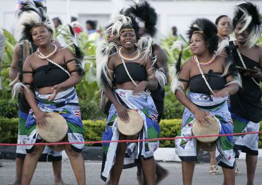 Young women in traditional costume dance during welcoming ceremonies for President George W. Bush and Mrs. Laura Bush Saturday, Feb. 16, 2008, at Julius Nyerere International Airport in Dar es Salaam, Tanzania. White House photo by Shealah Craighead