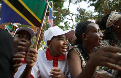 A young man waving a Tanzanian flag joins the well-wishers in the ceremonial arrival cordon Sunday, Feb. 17, 2008, to welcome President George W. Bush to Dar es Salaam. White House photo by Eric Draper