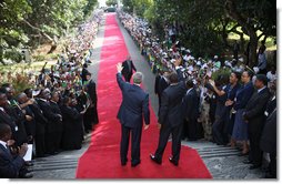  President George W. Bush and President Jakaya Kikwete of Tanzania, wave to the ceremonial arrival cordon as they reach the steps of the State House in Dar es Salaam Sunday, Feb. 17, 2008. White House photo by Eric Draper