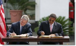 President George W. Bush and President Jakaya Kilwete of Tanzania sign the Millenium Challenge Compact Sunday, Feb. 17, 2008, at the State House in Dar es Salaam, Tanzania. White House photo by Chris Greenberg