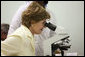 Mrs. Laura Bush views a medical slide thru a microscope Monday, Feb. 18, 2008, during a tour of the Meru District Hospital outpatient clinic in Arusha, Tanzania. White House photo by Eric Draper