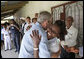 President George W. Bush embraces a hospital staff member Monday, Feb. 18, 2008, during a tour of the outpatient facility at the Meru District Hospital in Arusha, Tanzania. White House photo by Eric Draper