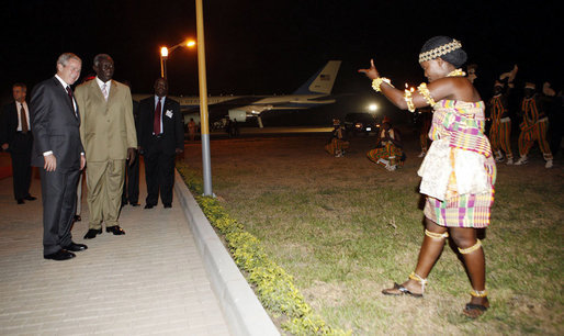 President George W. Bush and President John Agyekum Kufuor of Ghana watch a ceremonial dancer Tuesday, Feb. 19, 2008, upon the arrival of President Bush and Mrs. Laura Bush to Kotoka International Airport in Accra, Ghana. White House photo by Eric Draper
