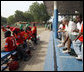 President George W. Bush talks with players during a tee ball game Wednesday, Feb. 20, 2008, at the Ghana International School in Accra, Ghana. White House photo by Eric Draper