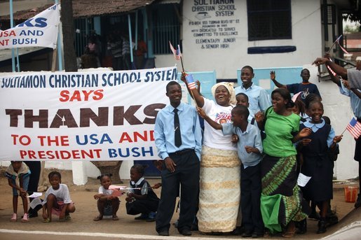 Students cheer and wave American flags as the motorcade of President George W. Bush and Mrs. Laura Bush travel Thursday, Feb. 21, 2008, to the Ministry of Foreign Affairs in Monrovia, Liberia. White House photo by Eric Draper
