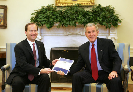 President George W. Bush receives a copy of the "Quiet Revolution" report Monday, Feb. 25, 2008, from Jay Hein, Director of the Office of Faith-Based and Community Initiatives, during a morning meeting in the Oval Office. White House photo by Joyce N. Boghosian