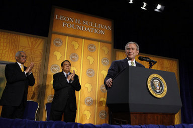 President George W. Bush receives applause during his remarks to The Leon H. Sullivan Foundation Tuesday, Feb. 26, 2008, in Washington, D.C. Joining the President on stage are Ambassador Andy Young, Chairman of the Board, Leon H. Sullivan, background center, and Ambassador Howard Jeter, president and CEO of The Leon H. Sullivan Foundation. White House photo by Eric Draper