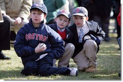 Young kids sit in awe wearing Boston Red Sox caps and holding baseballs hoping to get autographs during the Red Sox visit to the White House Wednesday, Feb. 27, 2008, on the South Lawn. White House photo by Chris Greenberg
