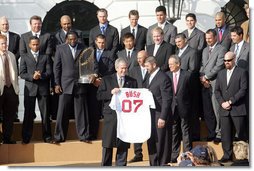 President George W. Bush is presented with a personalized Boston Red Sox jersey from team captain Jason Varitek, as President Bush honored the 2007 World Series Champions Wednesday, Feb. 27, 2008, on the South Lawn of the White House. White House photo by Joyce N. Boghosian