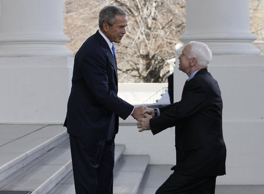 President George W. Bush shakes hands with Senator John McCain (R-Ariz.) as he arrived Wednesday, March 5, 2008, at the North Portico of the White House with his wife, Cindy. White House photo by Eric Draper