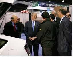 President George W. Bush stops to talk to the manufacturers of a converted plug-in hybrid electric vehicle during his tour of the Washington International Renewable Energy Conference 2008 Wednesday, March 5, 2008, at the Washington Convention Center in Washington, D.C. White House photo by Chris Greenberg