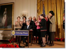 President George W. Bush is applauded by Mrs. Laura Bush, Cabinet members and members of Congress, at the proclamation signing for Women's History Month Monday, March 10, 2008 in the East Room of the White House in honor of Women's History Month and International Women's Day. From left are, U.S. Secretary of Labor Elaine Chao, U.S. Secretary of Transportation Mary Peters; New York Rep. Carolyn Mahoney, Rep. Marsha Blackburn of Tennessee, Rep. Judy Biggert of Illinois, Rep. Mary Fallin of Oklahoma, Rep. Shelley Moore Capito of West Virginia, Rep. Dianne Watson of California and Rep. Jean Schmidt of Ohio. White House photo by Joyce N. Boghosian