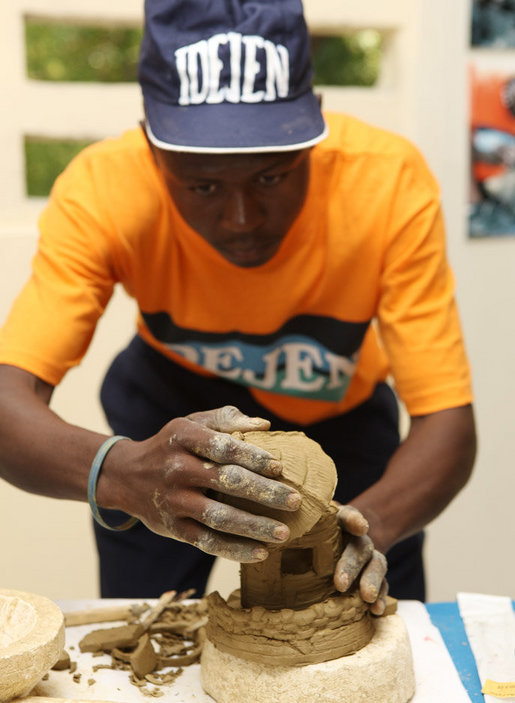 A student works on a sculpture Thursday, March 13, 2008, during Mrs. Laura Bush's visit to the IDEJEN educational program at the College de St. Martin Tours, in Port-au-Prine, Haiti. White House photo by Shealah Craighead