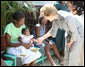 Mrs. Laura Bush is introduced to a participant and her infant daughter at the GHESKIO HIV/AIDS Center’s women’s clinic, Thursday, March 13, 2008, in Port-au-Prince, Haiti. The program was initiated to help improve the lives of HIV patients. White House photo by Shealah Craighead