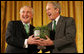President George W. Bush breaks out in laughter as he's presented a bowl of shamrocks from Prime Minister Bertie Ahern of Ireland during a reception Monday, March 17, 2008, in celebration of St. Patrick's Day. White House photo by Joyce N. Boghosian