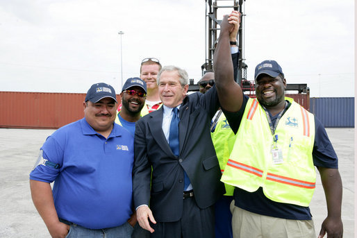 President George W. Bush joins port workers for a photo following his remarks on U.S. trade policy Tuesday, March 18, 2008, at the Blount Island Marine Terminal in Jacksonville, Fla. White House photo by Chris Greenberg