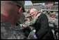 Vice President Dick Cheney greets U.S. troops and poses for pictures Tuesday, March 18, 2008, during a rally at Balad Air Base, Iraq. White House photo by David Bohrer