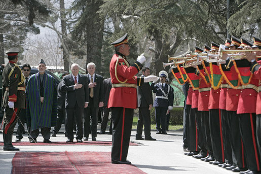 Vice President Dick Cheney is joined by President Hamid Karzai of Afghanistan for the playing of the national anthem of the United States Thursday, March 20, 2008, during an arrival ceremony at Gul Khana Palace in Kabul. While in Afghanistan the Vice President held meetings with President Karzai and visited Bagram Air Base for a classified briefing and dinner with U.S. troops. White House photo by David Bohrer