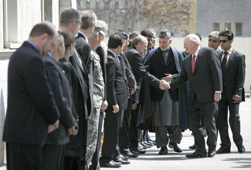 Vice President Dick Cheney is escorted by President of Afghanistan Hamid Karzai as he greets Afghan officials upon arrival to Gul Khana Palace in Kabul Thursday, March 20, 2008. The Vice President met with President Karzai and Afghan officials to reaffirm America's commitment to Afghanistan and discuss ways the U.S. would continue to help Afghanistan become a more prosperous and stable nation. White House photo by David Bohrer