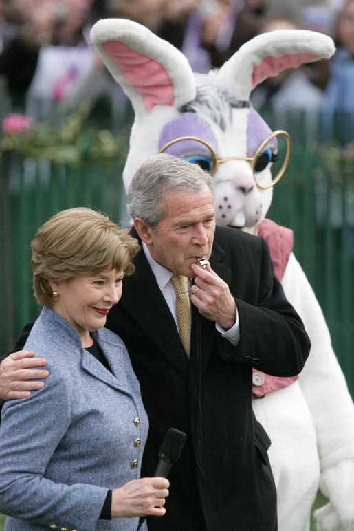 President George W. Bush embraces Mrs. Laura Bush as he blows a whistle Monday, March 24, 2008 on the South Lawn of the White House, to officially start the festivities for the 2008 White House Easter Egg Roll. White House photo by Chris Greenberg