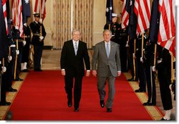 President George W. Bush and Australian Prime Minister Kevin Rudd walk together through Cross Hall to the East Room of the White House Friday, March 28, 2008, for their joint press availability. White House photo by Joyce N. Boghosian
