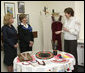 A volunteer briefs Mrs. Laura Bush and Mrs. Kateryna Yushchenko during their visit Tuesday, April 1, 2008, to the Ukraine Peace Corps headquarters in Kyiv. Mrs. Bush thanked all the volunteers for their service, telling them that during their 27 months of service, they serve as ambassadors for the United States, "sharing the best of our country with those who may never come into contact with another American." White House photo by Shealah Craighead
