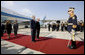 President George W. Bush stands with President Traian Basescu of Romania, during welcoming ceremonies Wednesday, April 2, 2008, at Mihail Kogalniceanu Airport in Constanta, Romania. With them on the red carpet are Mrs. Laura Bush and Mrs. Maria Basescu. White House photo by Eric Draper