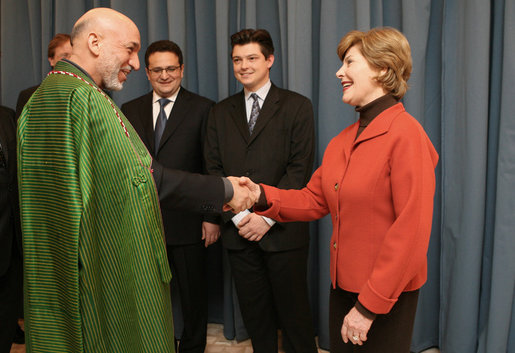 Mrs. Laura Bush greets Afghanistan President Hamid Karzai at the Headquarters of the Romanian Intelligence Service Thursday, April 3, 2008, where they participated in the Young Atlanticist Summit Video Conference with Kabul University. White House photo by Shealah Craighead