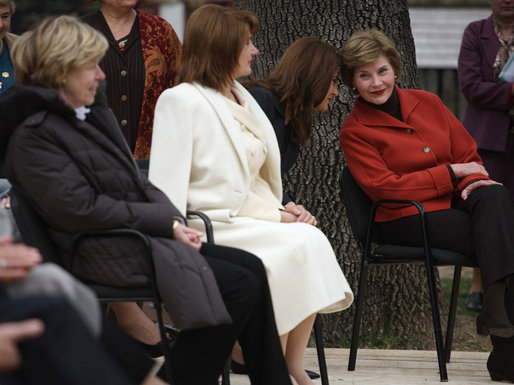 Mrs. Laura Bush leans in to listen to Alexandra Coman, fiance of Romania’s Foreign Minister Adrian Cioroianu, as they join other guests, including Mrs. Maria Basescu, in white, spouse of Romania’s President Taian Basescu, and Mrs. Jeannie de Hoop Scheffer, spouse of NATO Secretary General Jaap de Hoop Scheffer, at the Dimitrie Gusti Village museum in Bucharest. White House photo by Shealah Craighead