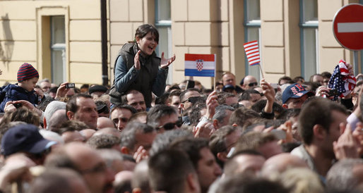 A young girl, atop the shoulders of a friend to get a better view, applauds in the crowd at Zagreb's St. Mark's Square as President George W. Bush addresses the thousands who turned out to welcome him Saturday April 5, 2008. White House photo by Shealah Craighead