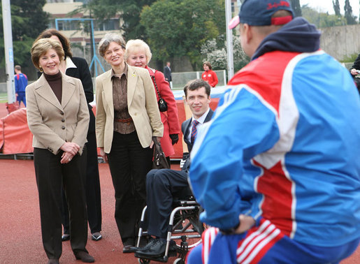 Mrs. Laura Bush visits with members of the Russian Paralympic Team Sunday, April 6, 2008, during a visit to Central Sochi Stadium in Sochi, Russia. Standing with her is her interpreter, Marina Gross. White House photo by Shealah Craighead