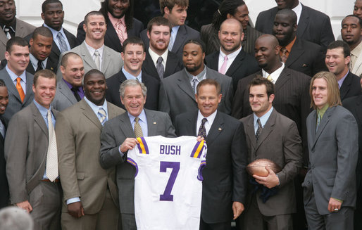 President George W. Bush holds up an LSU Tigers' jersey presented to him Monday, April 7, 2008 by the 2007 NCAA Football Champions during their visit to the White House. White House photo by Chris Greenberg