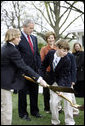 President George W. Bush and Mrs. Laura Bush watch as the young relatives of President Benjamin Harrison shovel dirt to help plant a Scarlet Oak tree Wednesday, April 9, 2008, at the commemorative tree planting on the North Lawn of the White House. The Scarlet Oak replaces a tree planted by President Benjamin Harrison that fell on October, 25, 2007. White House photo by Eric Draper