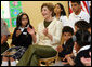 Mrs. Laura Bush applauds program speakers as she joins students from the Williams Preparatory School in Dallas, Thursday, April 10, 2008, during events at the First Bloom program to help encourage youth to get involved with conserving America's National Parks. Through the First Bloom program, the National Park Foundation and the National Park Services are joining with the Lady Bird Johnson Wildflower Center and community groups to connect young people to our national parks. White House photo by Shealah Craighead