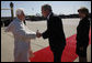 President George W. Bush takes the hand of Pope Benedict XVI as he and Mrs. Laura Bush welcomed the Pope to the United States upon his landing at Andrews Air Force Base, Maryland. Pope Benedict will visit the White House Wednesday and celebrate Mass Thursday before continuing on to New York City. White House photo by Eric Draper