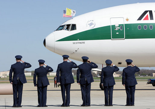 Military personnel salute as the Alitalia jetliner carrying Pope Benedict XVI arrives at Andrews Air Force Base. The Pontiff will be welcomed Wednesday at the White House and will celebrate Mass Thursday morning before continuing his U.S. visit in New York City. White House photo by Chris Greenberg