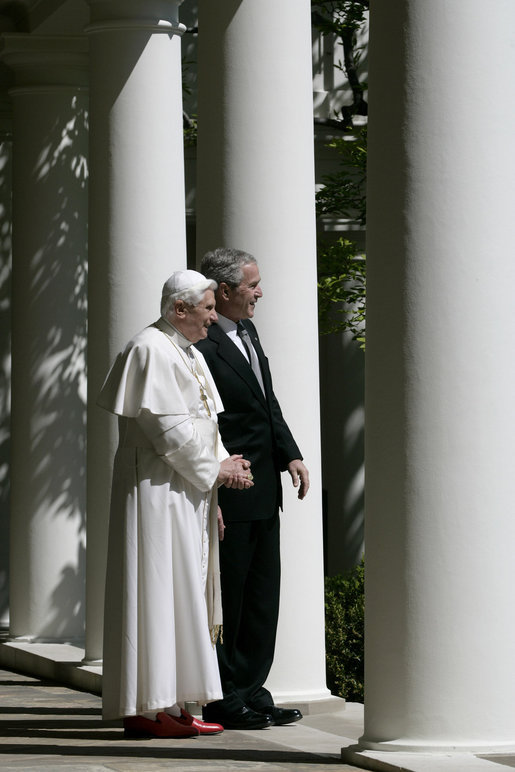 President George W. Bush and Pope Benedict XVI look out onto the Rose Garden from the Colonnade of the White House before their meeting Wednesday, April 16, 2008. The visit of Pope Benedict XVI is the first White House papal visit in three decades. White House photo by David Bohrer