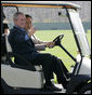 President George W. Bush waves as South Korean President Lee Myung-bak drives their golf cart Friday, April 18, 2008, at the Presidential retreat at Camp David, Md. White House photo by Joyce N. Boghosian