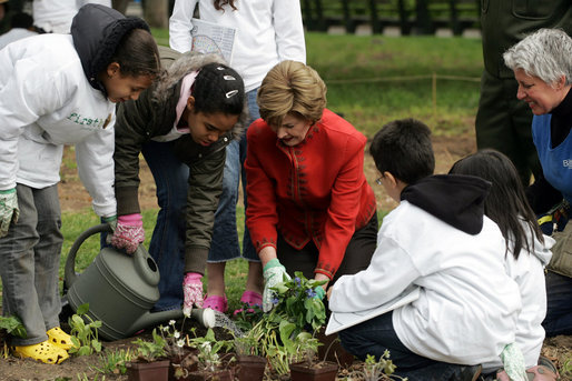 Mrs. Laura Bush helps children plant flowers at the First Bloom Event, Monday, April 21, 2008, during her visit to celebrate National Park week at the Castle Clinton National Monument in New York City. White House photo by Shealah Craighead