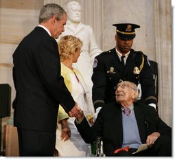 President George W. Bush offers his hand to Dr. Michael DeBakey Wednesday, April 23, 2008, after honoring the 99-year-old pioneer of bypass heart surgery during the Congressional Gold Medal Ceremony at the U.S. Capitol.  White House photo by Chris Greenberg