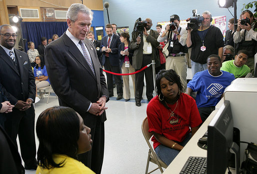 President George W. Bush looks over the shoulders of middle school students as they work on projects for Malaria Awareness Day Friday, April 25, 2008, during his visit to the Northwest Boys & Girls Club in Hartford, Conn. White House photo by Chris Greenberg