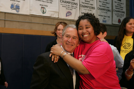 President George W. Bush is embraced by Boys and Girls Club member Melodie Williams as they pose for a photo Friday, April 25, 2008, during the President's visit to the Northwest Boys & Girls Club in Hartford, Conn., where the Boys & Girls members were learning about the cause and prevention of malaria. White House photo by Chris Greenberg