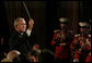 President George W. Bush leads the Marine Band Saturday, April 26, 2008, during the 94th Annual White House Correspondents' Association Dinner at the Washington Hilton Hotel.  White House photo by Joyce N. Boghosian
