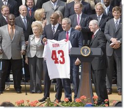 President George W. Bush holds a New York Giants jersey, presented to him by Giants wide receiver Amani Toomer Wednesday, April 30, 2008, as part of an event honoring the Super Bowl XLII Champions on the South Lawn of the White House. White House photo by Shealah Craighead